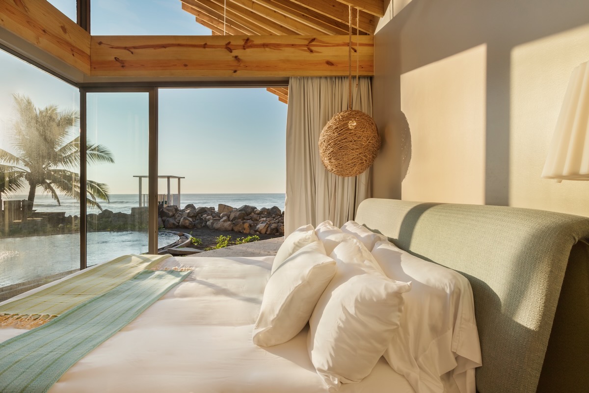 A white sheeted bed inside of Al Suave House