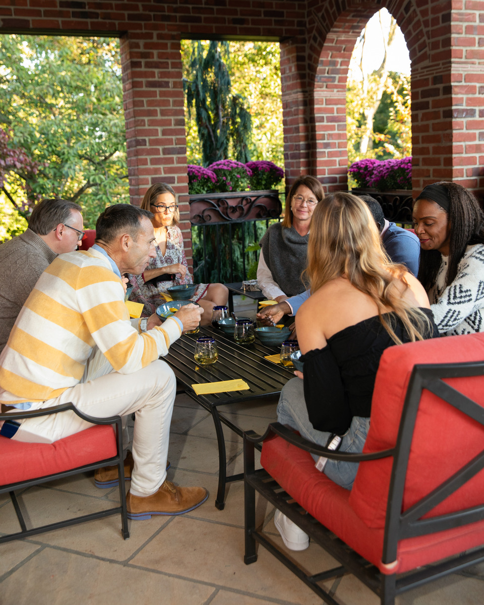 A group of friends and family gathered for an informal outdoor gathering.