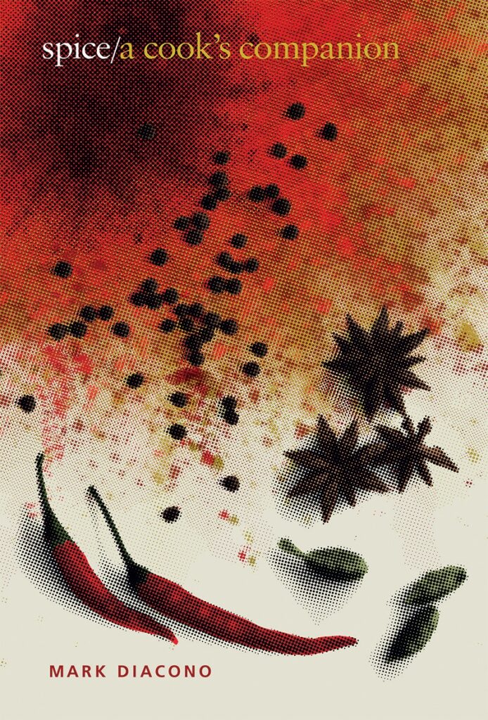 The cover of a spices book featuring a burst of red and orange as well as chili peppers and anise stars.