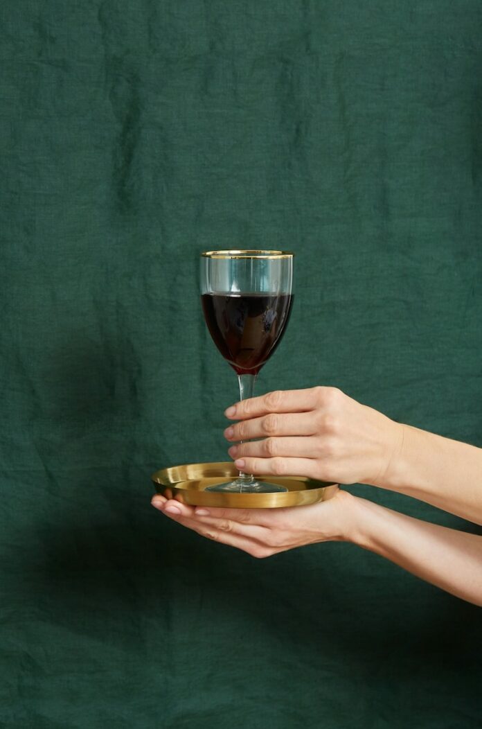 A glass of wine on a green background