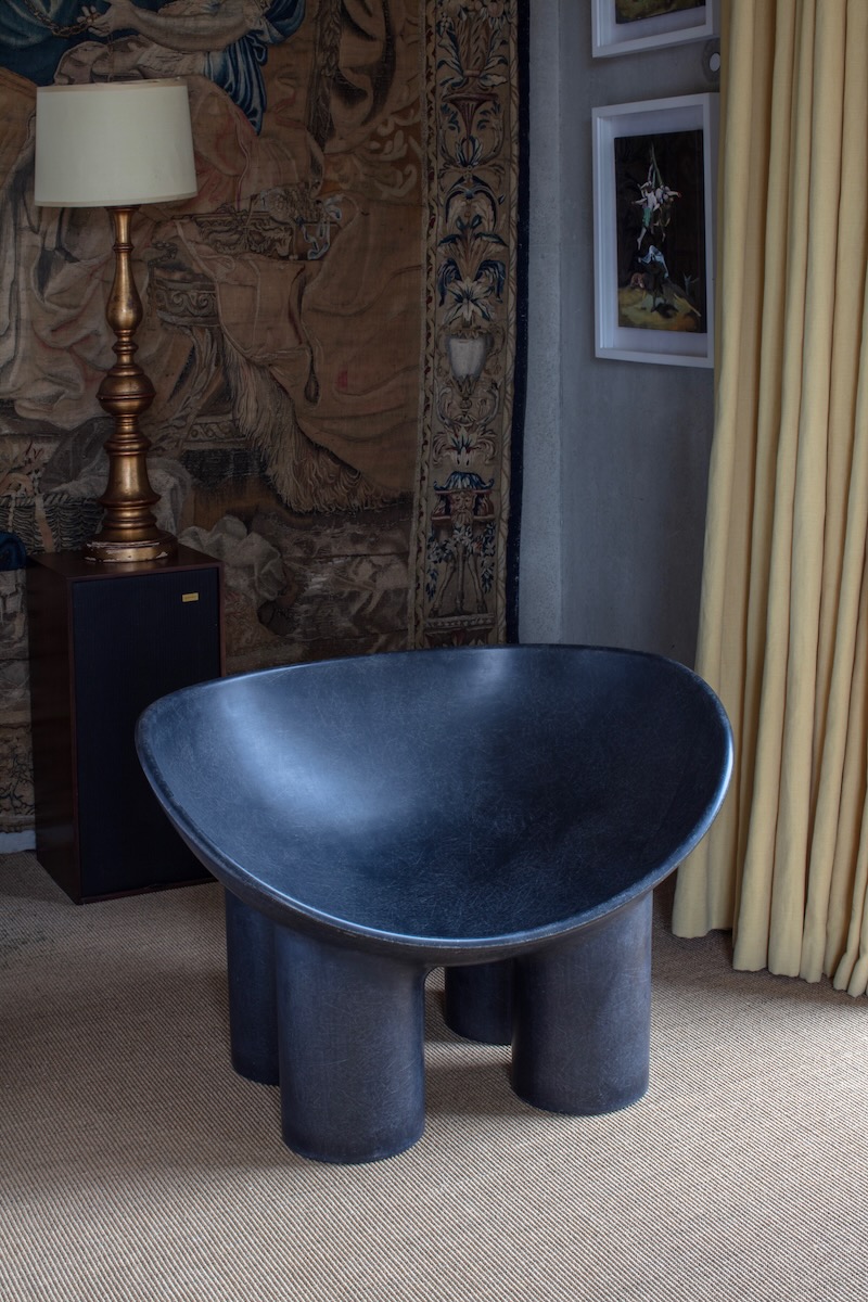 The Roly-Poly Chair, designed by Faye Toogood, sits in a home with a beige rug
