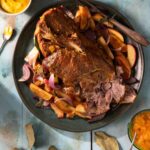 Apple mustard braised pork staged with bowls of Shenot's mustard.