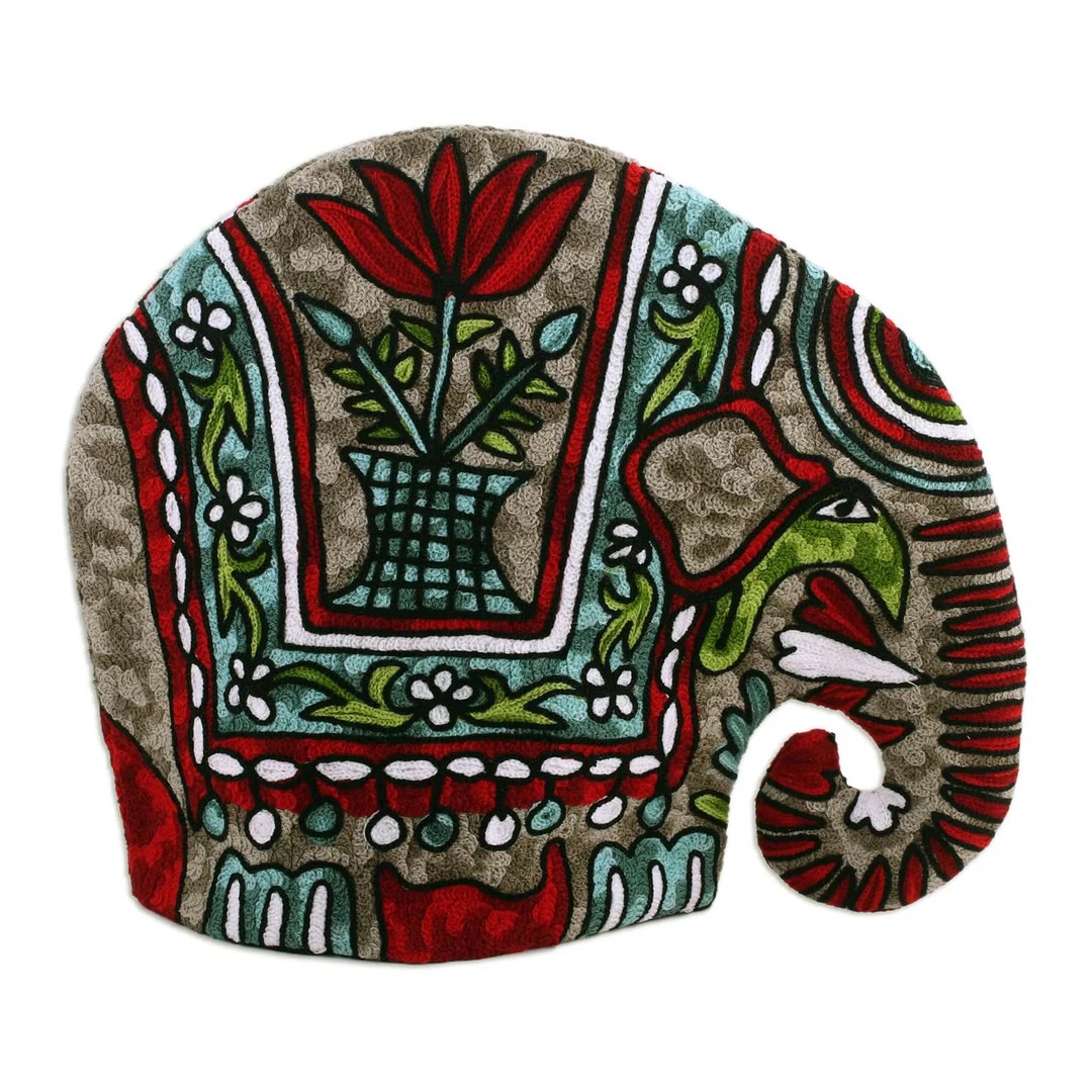 An elephant-shaped tea cozy with green and red embroidery on it.