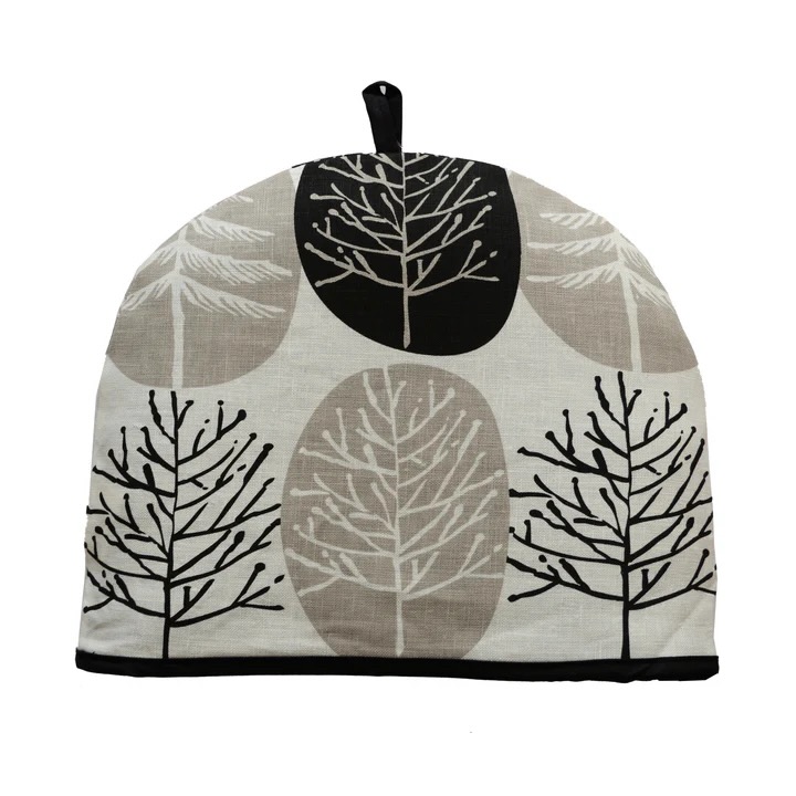 A beige and white tea cozy with a black tree design o it.