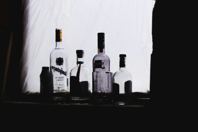 Vodka Isn't Just for Shots and Soda Bottles of vodka sit on a dark street, illuminated in a patch of white light.