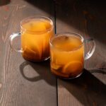 Two cups of boilo on a wooden background.