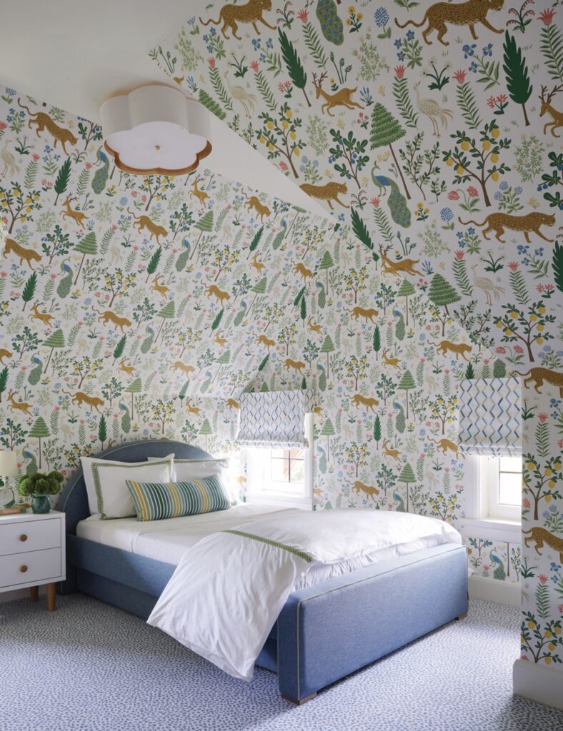 A child's room by Betsy Wentz features nature wallpaper and a white bed with green accents.
