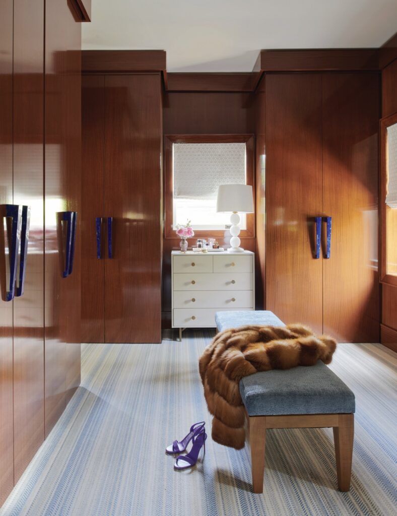 Two deep brown wood closets sit on either side of a white dresser.