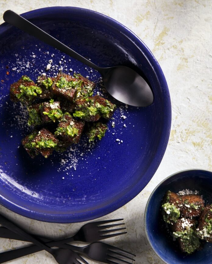 A blue bowl of Gnocchi alla Romana with Pesto Genovese