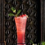 A red cocktail on a black background from Dan Ball of Hyeholde.