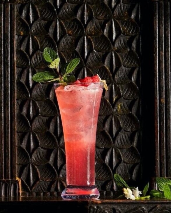 A red cocktail on a black background from Dan Ball of Hyeholde.