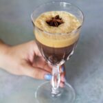 An iced caffè coretto with a garnish of anise.