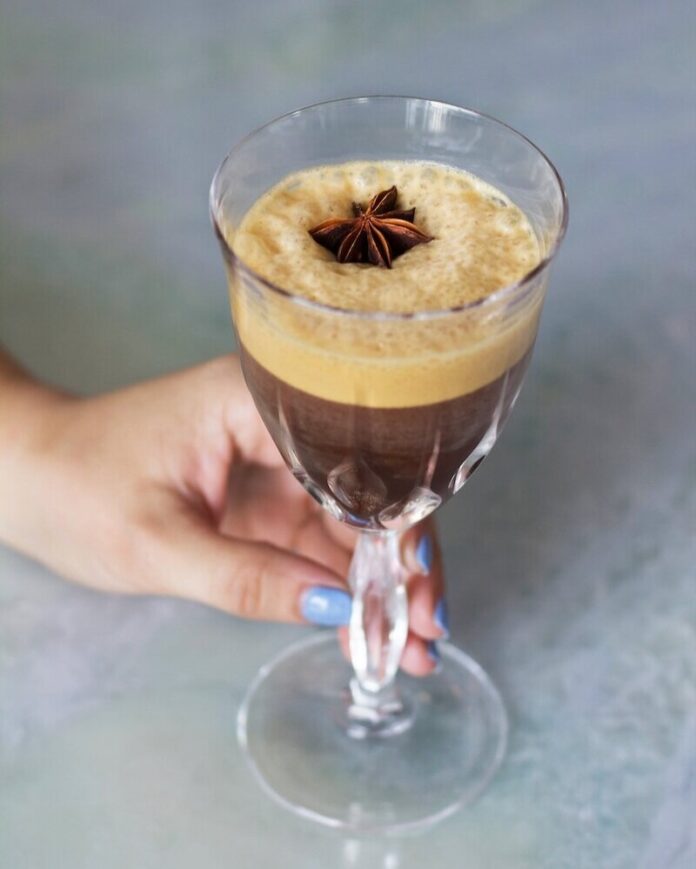An iced caffè coretto with a garnish of anise.