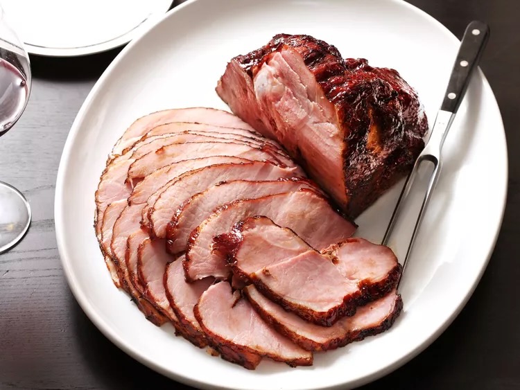 Slices of sous vide city ham on a white background.