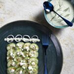 An english cucumber salad with kefir dressing on a white background.