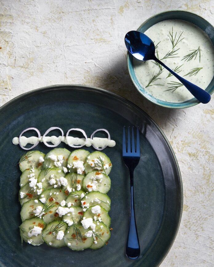 An english cucumber salad with kefir dressing on a white background.