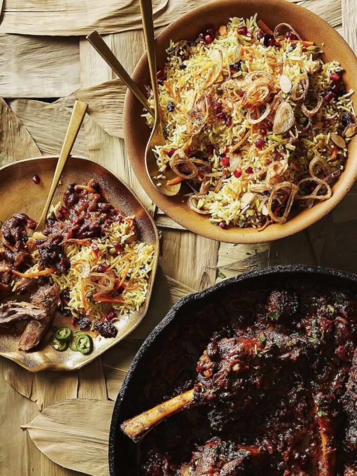 Persian Jeweled rice at a festive Nowruz table, served with chutney and lamb.