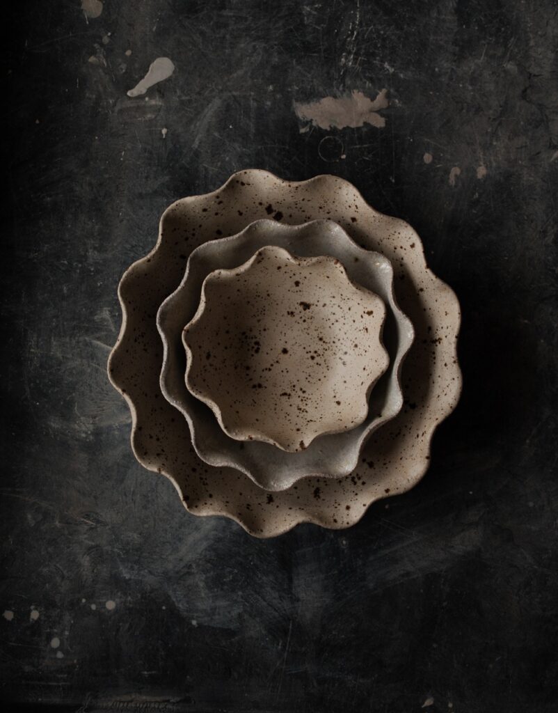 Three neutral grey bowls stacked into each other to represent 2025 design trends.