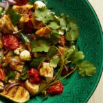 Panzanella with roasted tomatoes on a green dish