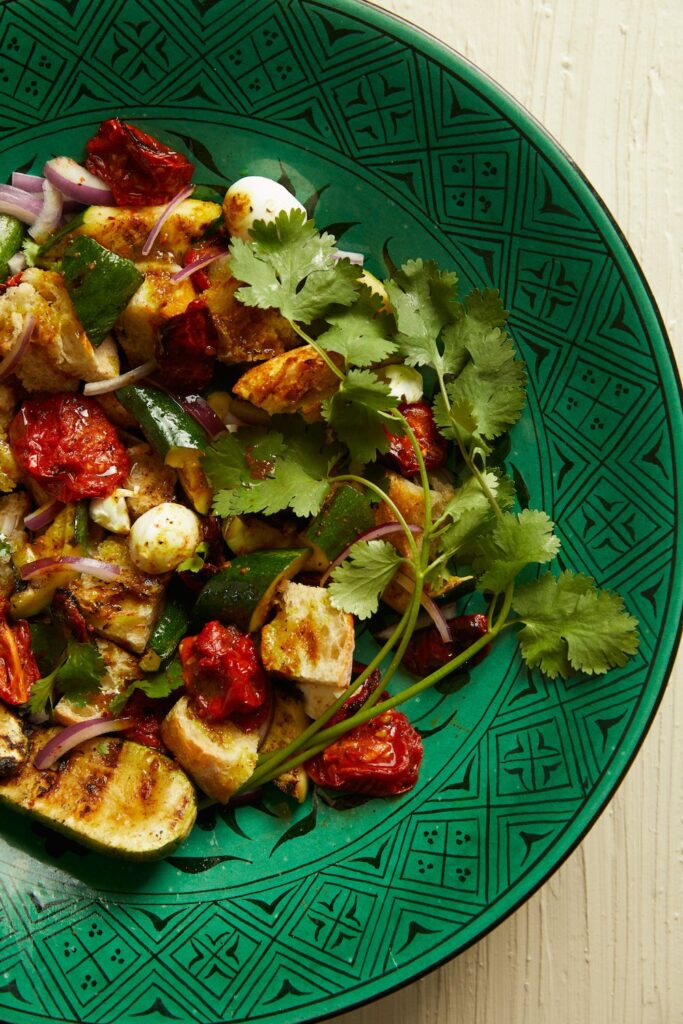 Panzanella with roasted tomatoes on a green dish