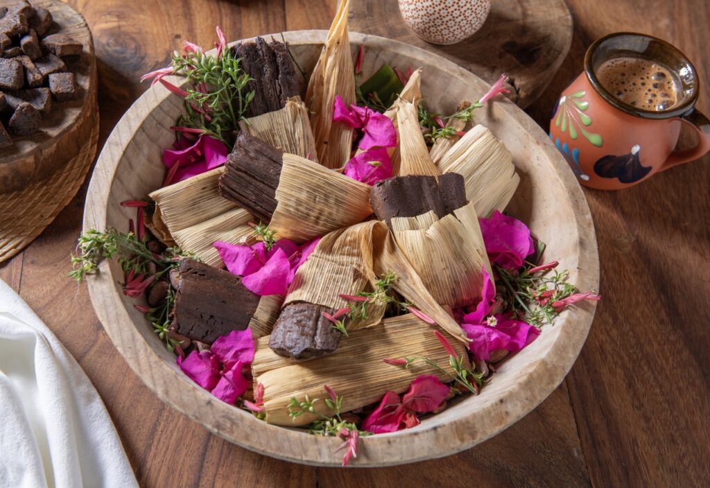 A bowl of tamales mixed with pink flowers at Playa Viva.