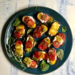 Tomato-Ricotta-Burschetta on dark plate with light background