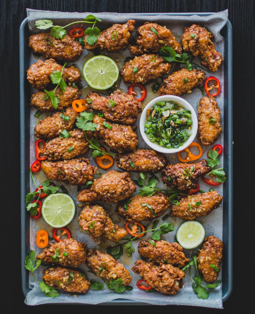 An above shot of a baking sheet filled with Vietnamese Chicken Wings.