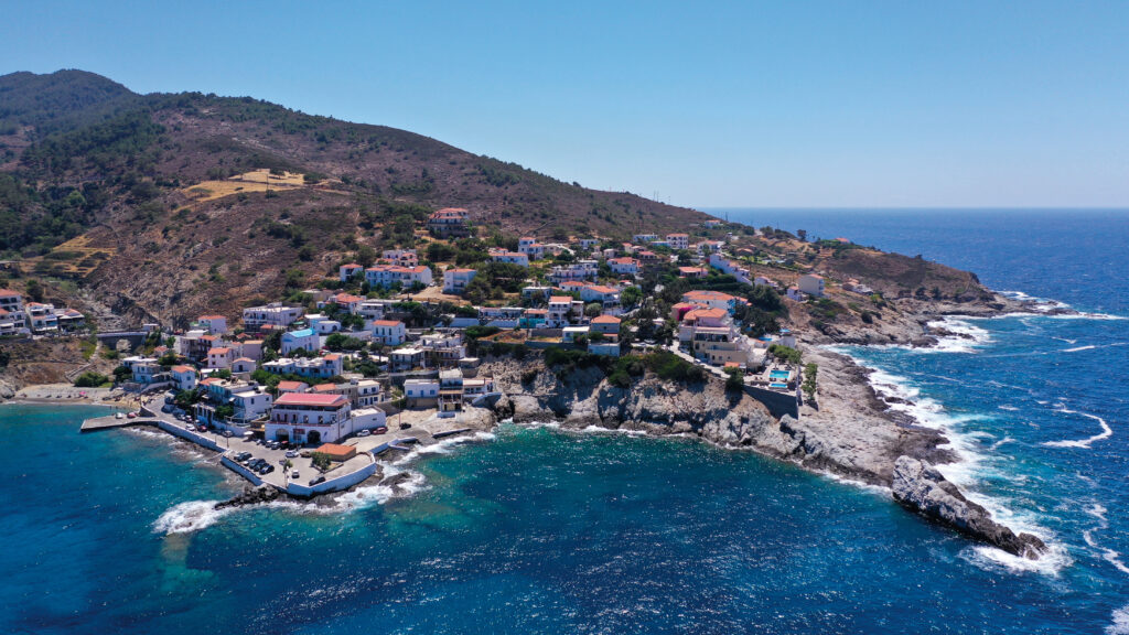 The shorelines of Greece. Aerial drone photo of small picturesque seaside village of Armenistis in island of Ikaria, Aegean, Greece; Shutterstock ID 2254061193; purchase_order: 9781250880000; job: The Ikaria Way; client: SMP cookbook; other: michelle