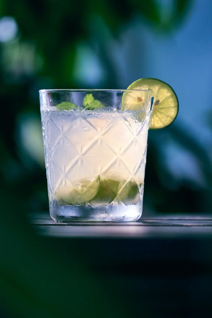 In a high ball glass sits a clear-ish drink, called Bet the Ranch