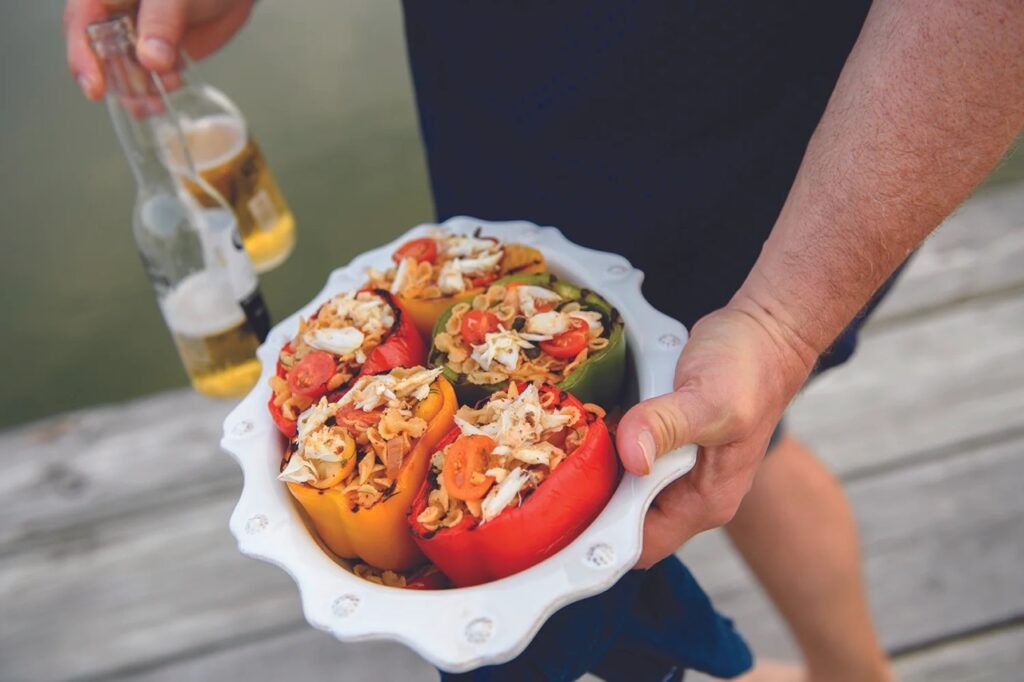 A bowl full of stuffed peppers full of crab.