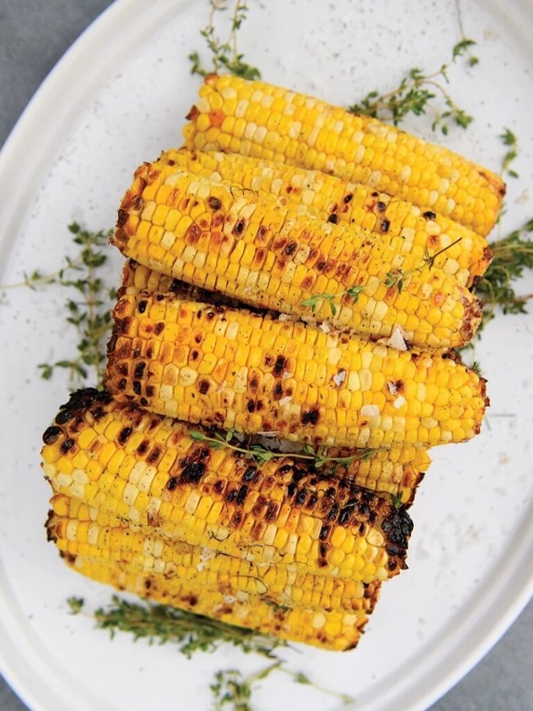 A pile of grilled corn on the cob.