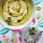 An above shot of a bowl filled with a yellow, Chilled Cauliflower Soup.