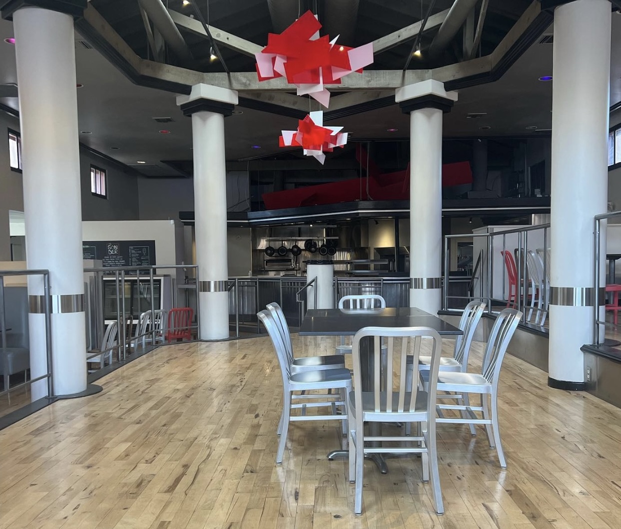 inside view of capitol coal with silver chairs and hanging red lighting
