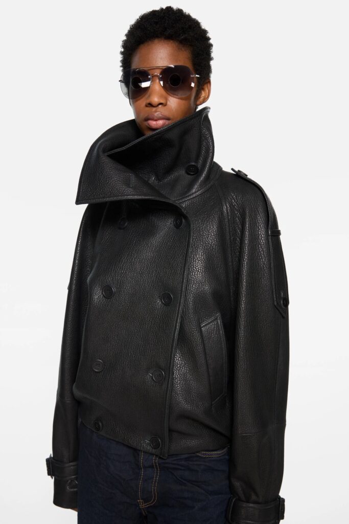 A man in a large black leather jacket.