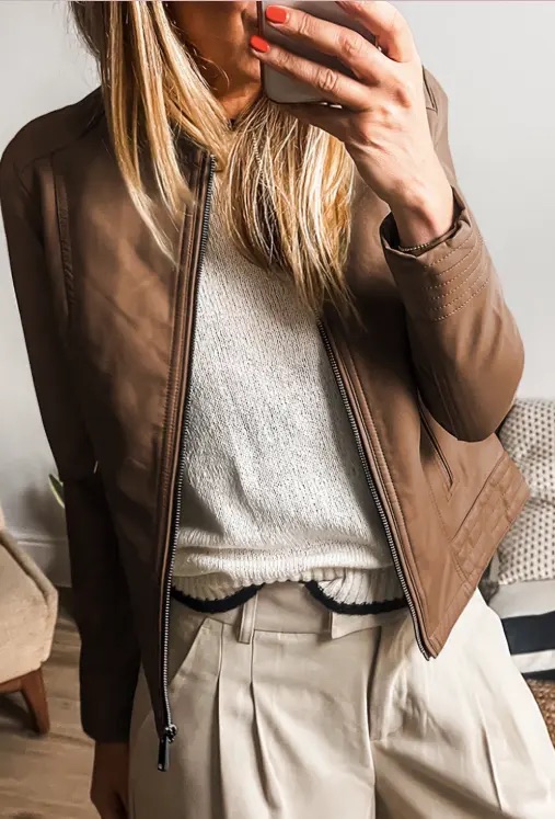 A woman in a plush brown jacket.
