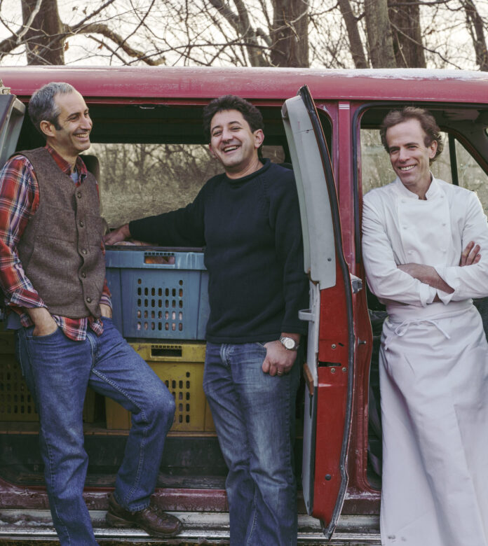 three chefs standing in front of red van with seeds