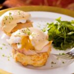 Smoked trout eggs benedict on biscuits with all-in-one hollandaise sauce and a side of fresh arugula.