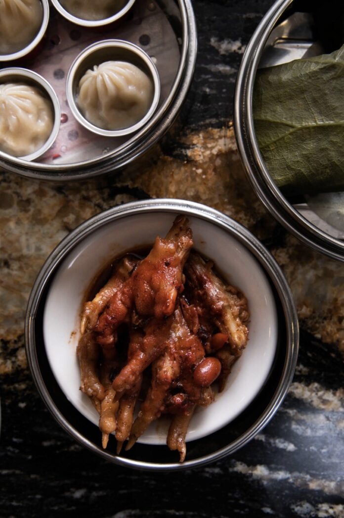 Steamed Ribs A bowl full of steamed ribs with dumplings sitting above it.