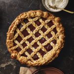 A pie with purple potatoes and bourbon honey with lattice work over top.
