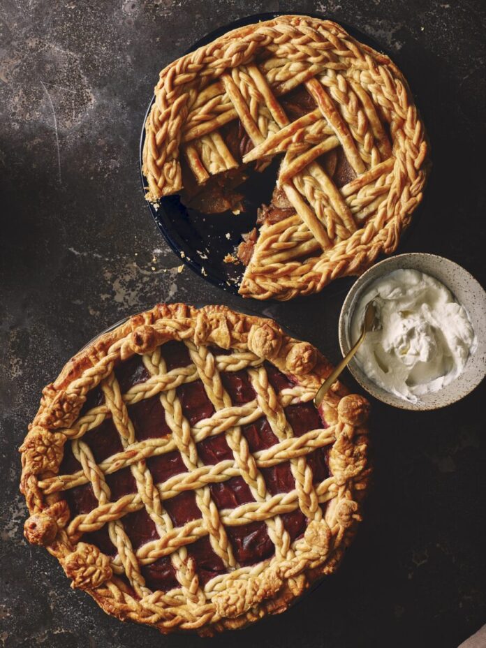 Two pies with fancy lattice work homemade pie crust.