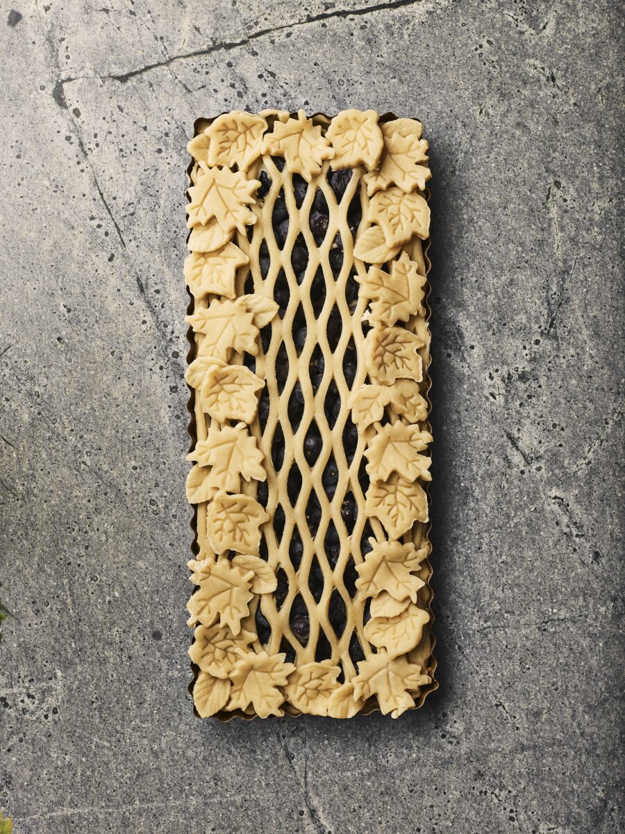 A pie crust with lattice work over top.