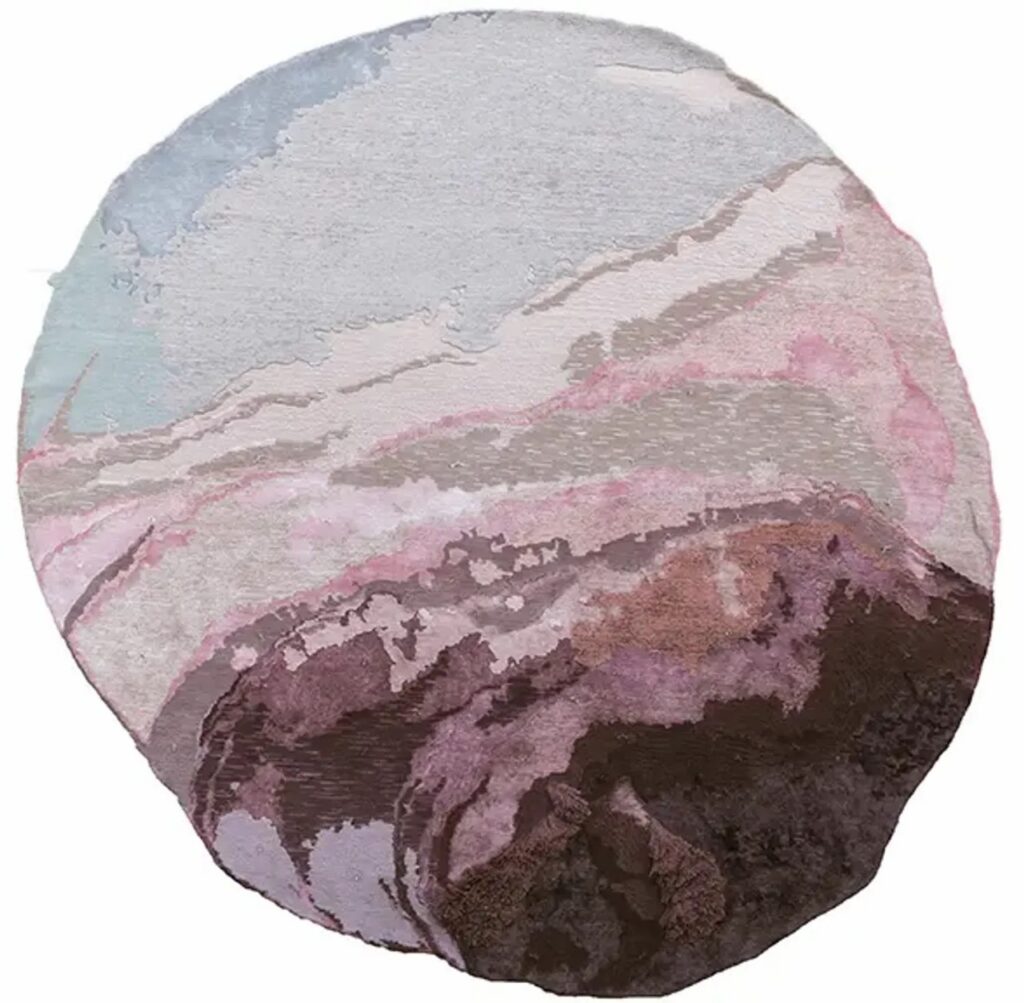 A circular rug in purple and grey colors.