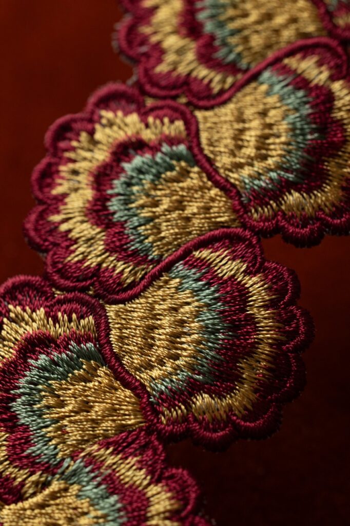 Embroidered flowers in yellow, red, and green.
