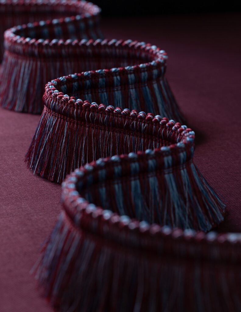 A line of purple and lavender colored tassels.