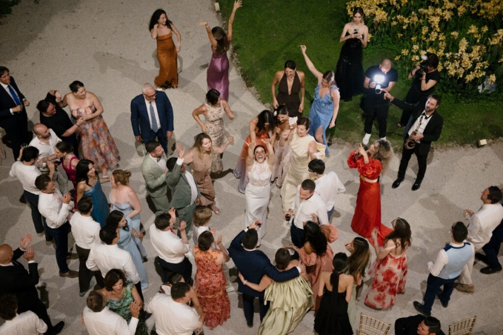 An overhead view of bride Cristina Bartolacci dancing with wedding guests and a live singer.