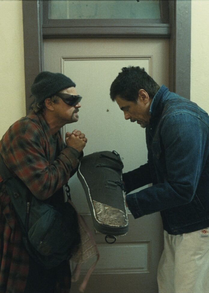 Leonardo Dicaprio takes a case from Benicio del Toro in Oscar-nominee One Battle After Another.