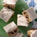 Bourbon Cookie Bars sit frosted on a green plate.