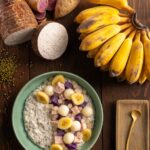 Sweet potatoes and Thai bananas sit above a green bowl of Guinataang Munggo (Mung Bean Porridge) with jackfruit and banana slices on top.