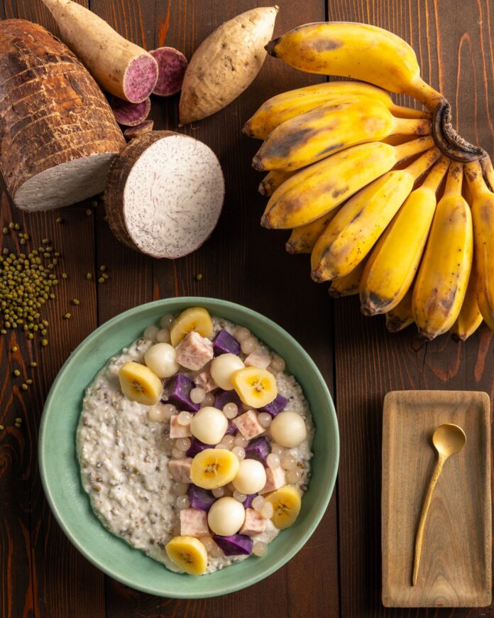 Sweet potatoes and Thai bananas sit above a green bowl of Guinataang Munggo (Mung Bean Porridge) with jackfruit and banana slices on top.