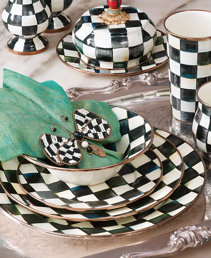 A stack of black and white checker plates and other tableware.